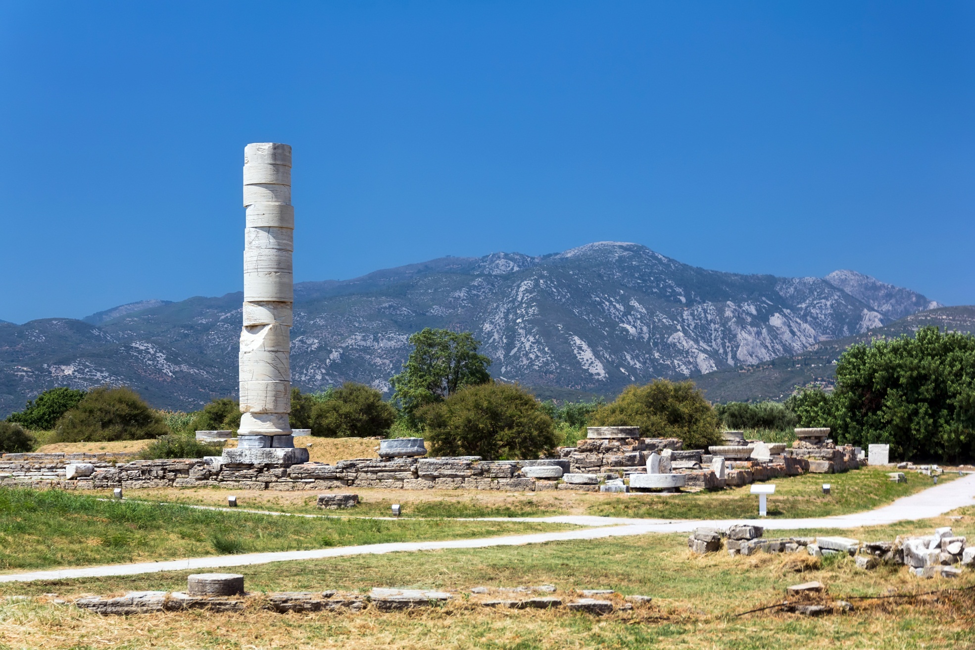 remains of the temple of hera in samos. one column remains standing.